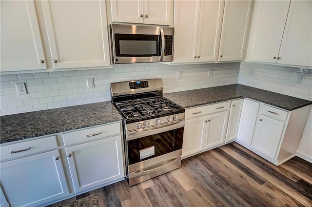 108 Brassy St, Suffolk, VA 23434 - kitchen with appliances with stainless steel finishes, dark wood-style flooring, white cabinetry, and dark stone counters