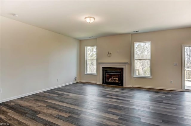 108 Brassy St, Suffolk, VA 23434 - unfurnished living room with plenty of natural light, dark wood-style floors, a fireplace with flush hearth, and baseboards