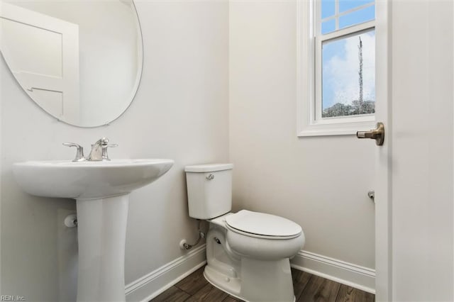 1544 Stanford Ln, Newport News, VA 23608 - half bathroom with baseboards, toilet, wood finished floors, and a sink
