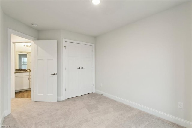 1544 Stanford Ln, Newport News, VA 23608 - unfurnished bedroom with light carpet, baseboards, and a closet