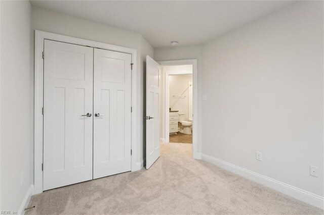 1544 Stanford Ln, Newport News, VA 23608 - unfurnished bedroom with light colored carpet, baseboards, and a closet