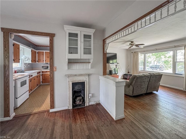 1625 Garfield Dr, Norfolk, VA 23503 - kitchen featuring electric stove, a fireplace, light countertops, a sink, and dark wood finished floors