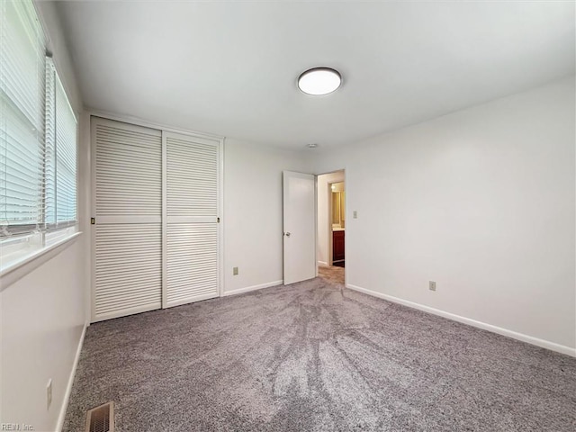 11 Redbud Ln, Newport News, VA 23602 - unfurnished bedroom featuring a closet, carpet, baseboards, and multiple windows
