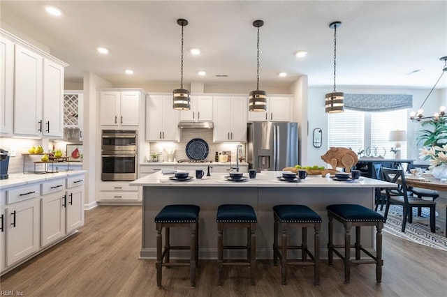 137 Preserve Way, Suffolk, VA 23434 - kitchen with appliances with stainless steel finishes, decorative backsplash, white cabinets, a kitchen breakfast bar, and recessed lighting