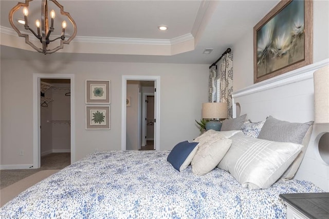 137 Preserve Way, Suffolk, VA 23434 - carpeted bedroom featuring a chandelier, a walk in closet, ornamental molding, a closet, and a tray ceiling
