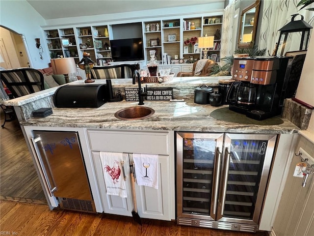 401 Muirfield, Smithfield, VA 23430 - bar area featuring beverage cooler, a sink, wood finished floors, and arched walkways