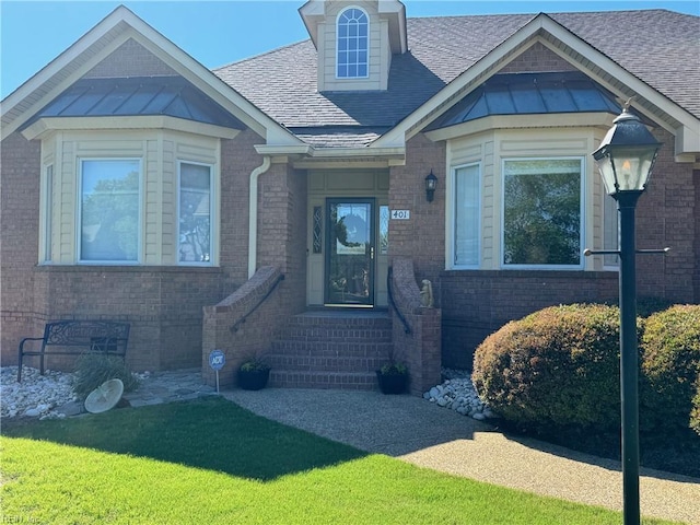 401 Muirfield, Smithfield, VA 23430 - view of front of home featuring brick siding, roof with shingles, a front lawn, and a standing seam roof