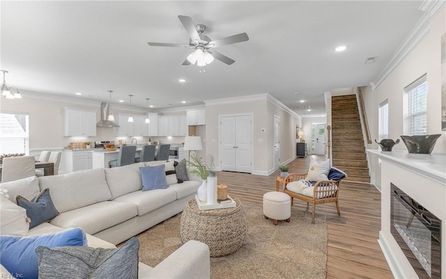1608 Holland Ave, Norfolk, VA 23509 - living room featuring light wood finished floors, ornamental molding, healthy amount of natural light, recessed lighting, and stairs