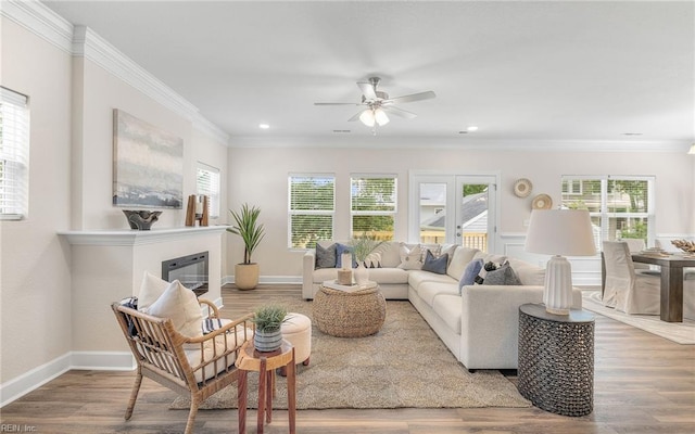 1608 Holland Ave, Norfolk, VA 23509 - living area with ceiling fan, healthy amount of natural light, wood finished floors, a glass covered fireplace, and crown molding
