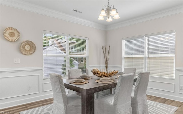 1608 Holland Ave, Norfolk, VA 23509 - dining area with a chandelier, light wood-type flooring, crown molding, wainscoting, and a decorative wall