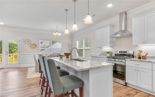 1608 Holland Ave, Norfolk, VA 23509 - kitchen with gas stove, wall chimney exhaust hood, a sink, healthy amount of natural light, and crown molding