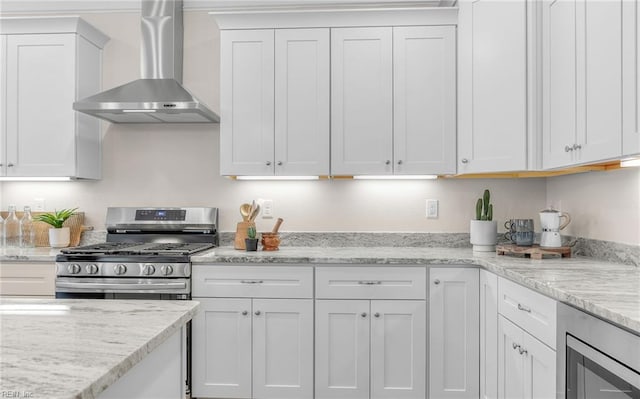 1608 Holland Ave, Norfolk, VA 23509 - kitchen featuring wall chimney exhaust hood, stainless steel appliances, white cabinets, and light stone countertops