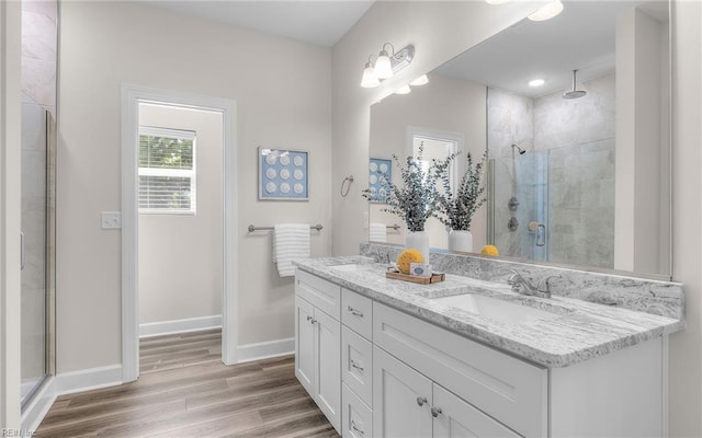 1608 Holland Ave, Norfolk, VA 23509 - full bath featuring wood finished floors, double vanity, a stall shower, and baseboards