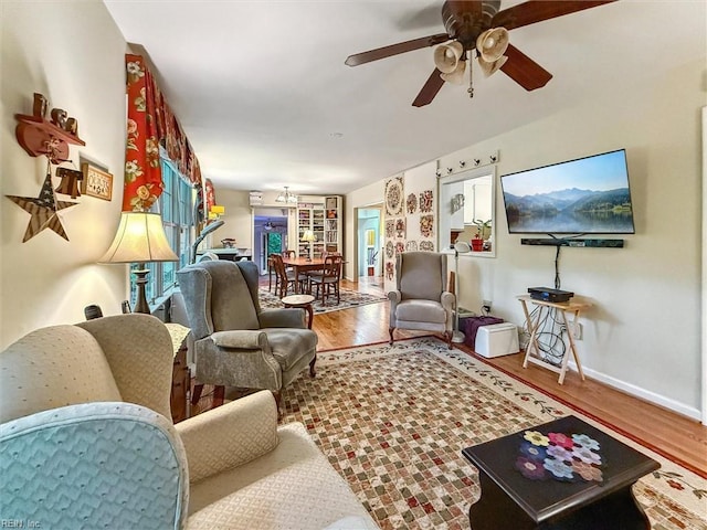 105 Stavenger Ct, Williamsburg, VA 23188 - living room with wood finished floors, baseboards, a ceiling fan, and a chandelier