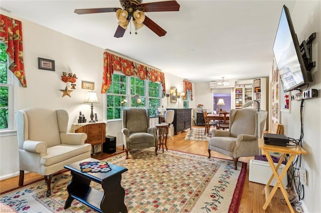 105 Stavenger Ct, Williamsburg, VA 23188 - living area with plenty of natural light, wood finished floors, and a chandelier