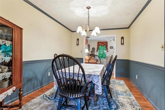 105 Stavenger Ct, Williamsburg, VA 23188 - dining room featuring ornamental molding, wood finished floors, a textured ceiling, a chandelier, and a ceiling fan