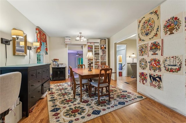 105 Stavenger Ct, Williamsburg, VA 23188 - dining area featuring light wood finished floors, a chandelier, and a ceiling fan