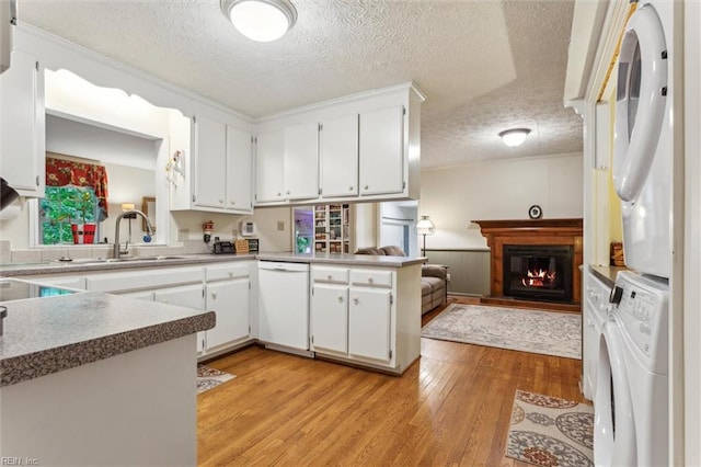 105 Stavenger Ct, Williamsburg, VA 23188 - kitchen featuring white dishwasher, a sink, light wood-type flooring, a textured ceiling, and open floor plan
