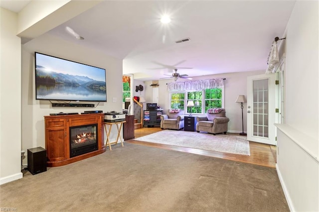 105 Stavenger Ct, Williamsburg, VA 23188 - carpeted living room with ceiling fan, a glass covered fireplace, and baseboards