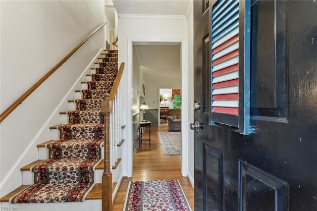 105 Stavenger Ct, Williamsburg, VA 23188 - entryway with stairs, wood finished floors, and crown molding