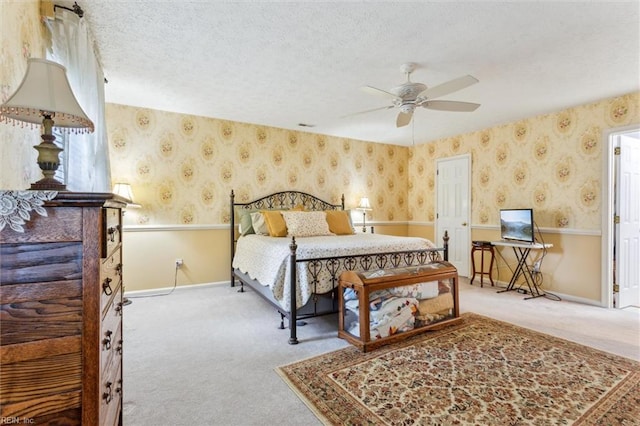 105 Stavenger Ct, Williamsburg, VA 23188 - carpeted bedroom featuring wallpapered walls, a textured ceiling, baseboards, and a ceiling fan