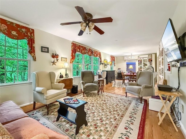 105 Stavenger Ct, Williamsburg, VA 23188 - living room featuring wood finished floors, plenty of natural light, a chandelier, and a ceiling fan