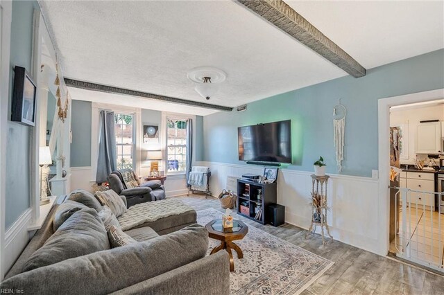 3317 Montana Ave, Norfolk, VA 23513 - living area with wainscoting, wood finished floors, a textured ceiling, and beamed ceiling