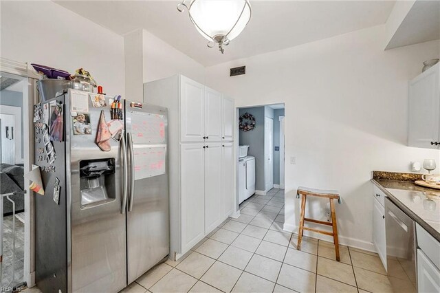 3317 Montana Ave, Norfolk, VA 23513 - kitchen with stainless steel appliances, light tile patterned floors, white cabinetry, and baseboards