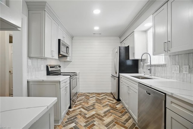 6223 Rolfe Ave, Norfolk, VA 23508 - kitchen with appliances with stainless steel finishes, a sink, brick flooring, wooden walls, and recessed lighting