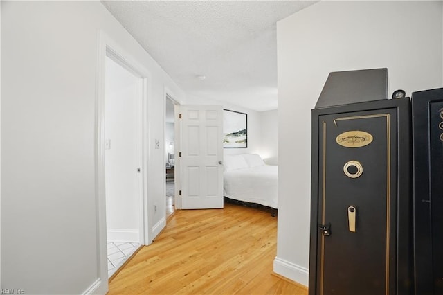 6223 Rolfe Ave, Norfolk, VA 23508 - hallway featuring light wood finished floors, baseboards, and a textured ceiling