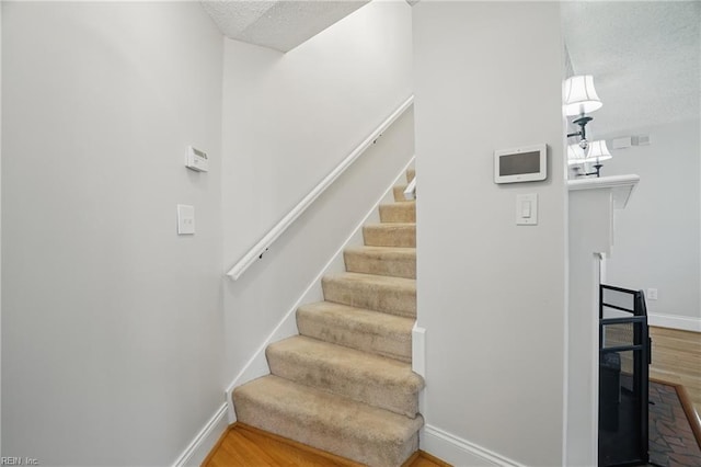 6223 Rolfe Ave, Norfolk, VA 23508 - stairs with wood finished floors, baseboards, and a textured ceiling