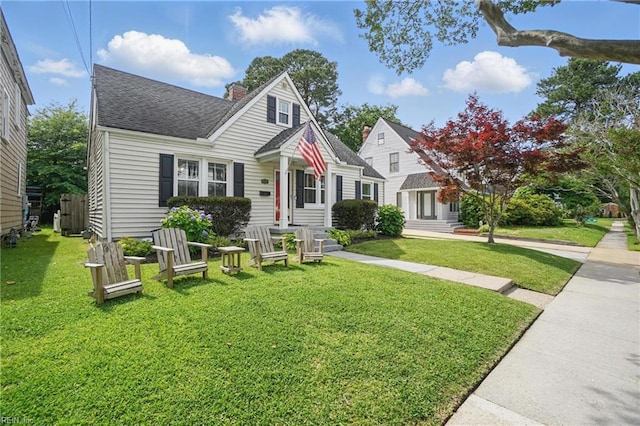 6223 Rolfe Ave, Norfolk, VA 23508 - view of front of home with a chimney, a front yard, and a shingled roof