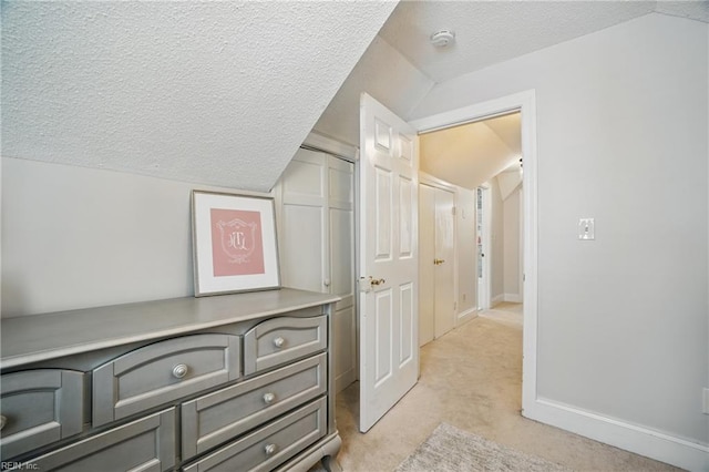 6223 Rolfe Ave, Norfolk, VA 23508 - corridor featuring light colored carpet, a textured ceiling, lofted ceiling, and baseboards