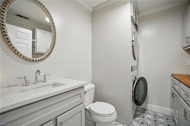 6223 Rolfe Ave, Norfolk, VA 23508 - bathroom featuring vanity, stacked washer / drying machine, toilet, crown molding, and baseboards