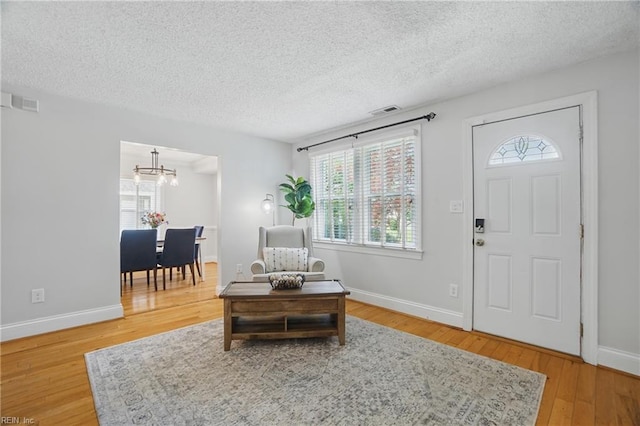 6223 Rolfe Ave, Norfolk, VA 23508 - foyer entrance featuring a chandelier, wood finished floors, a textured ceiling, and baseboards