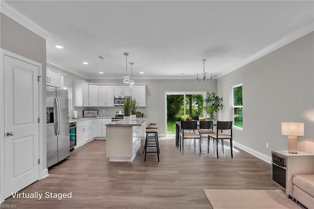 308 N Division St Unit A, Suffolk, VA 23434 - kitchen with appliances with stainless steel finishes, ornamental molding, recessed lighting, a breakfast bar, and light countertops