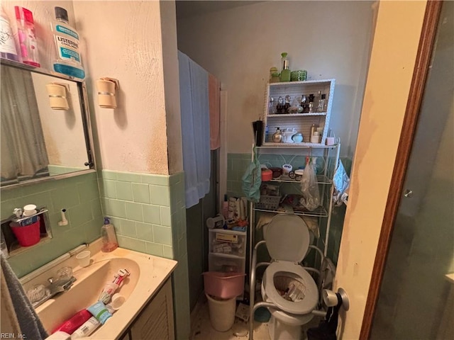 212 Breckinridge Ct, Hampton, VA 23666 - bathroom featuring tile walls, vanity, toilet, and a wainscoted wall