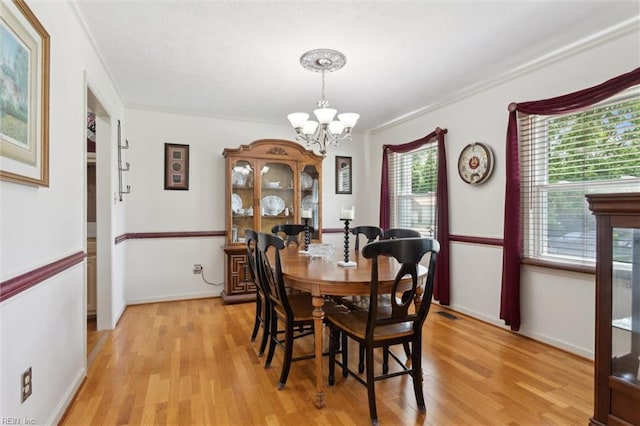 108 Silver Fox Trce, Yorktown, VA 23693 - dining space with ornamental molding, light wood-style flooring, a chandelier, and baseboards