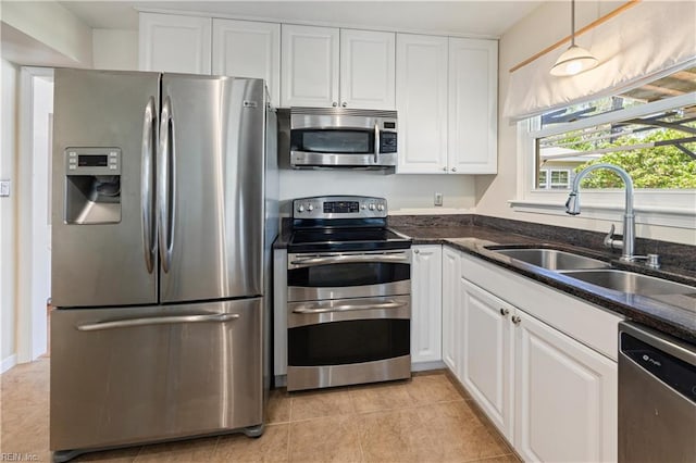 4456 Hudgins Dr, Virginia Beach, VA 23455 - kitchen featuring appliances with stainless steel finishes, a sink, white cabinetry, dark stone counters, and pendant lighting