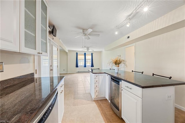 4456 Hudgins Dr, Virginia Beach, VA 23455 - kitchen featuring open floor plan, white cabinetry, dishwashing machine, glass insert cabinets, and light tile patterned flooring