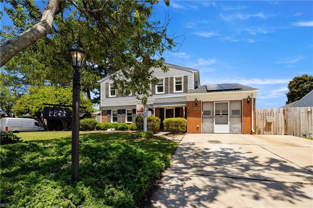 4456 Hudgins Dr, Virginia Beach, VA 23455 - view of front of house featuring brick siding, solar panels, and concrete driveway