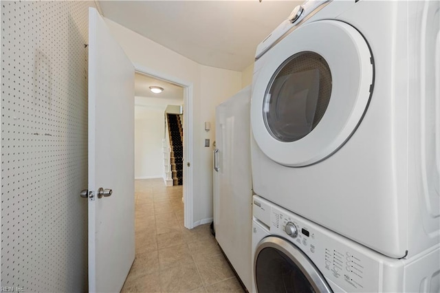 4456 Hudgins Dr, Virginia Beach, VA 23455 - washroom featuring estacked washer and dryer, light tile patterned flooring, and baseboards
