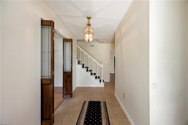 4456 Hudgins Dr, Virginia Beach, VA 23455 - foyer entrance featuring stairway, light tile patterned floors, and baseboards