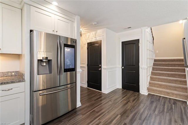 82 Beacon Rd, Portsmouth, VA 23702 - kitchen with stainless steel fridge with ice dispenser, white cabinetry, light stone countertops, and dark wood-style floors
