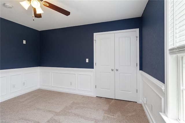 82 Beacon Rd, Portsmouth, VA 23702 - unfurnished bedroom with carpet, a wainscoted wall, a closet, and ceiling fan