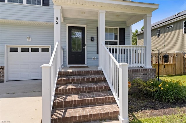 82 Beacon Rd, Portsmouth, VA 23702 - property entrance with a garage and a porch