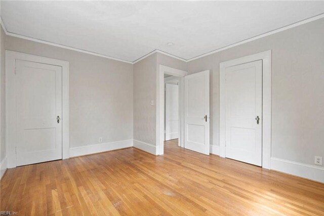 309 Linden Ave, Suffolk, VA 23434 - unfurnished bedroom featuring crown molding, light wood-type flooring, and baseboards