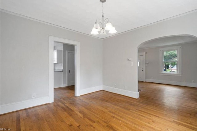 309 Linden Ave, Suffolk, VA 23434 - empty room with crown molding, arched walkways, a chandelier, baseboards, and hardwood / wood-style floors