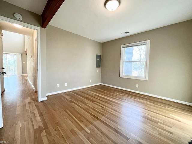 10104 Ogilvy Ln, Carrollton, VA 23314 - unfurnished room featuring wood finished floors, a smoke detector, baseboards, and electric panel