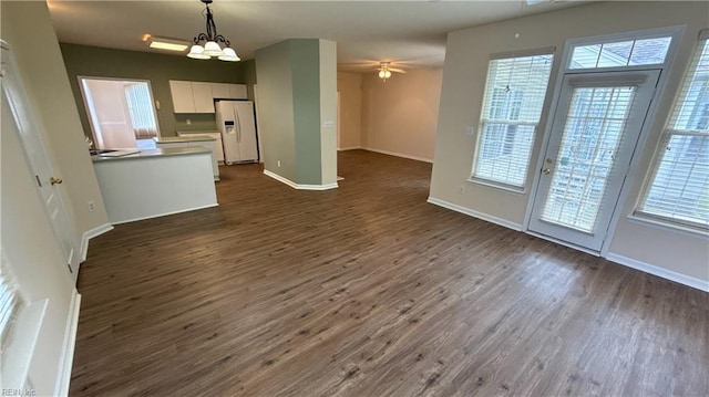 2019 River Pearl Way, Chesapeake, VA 23321 - unfurnished living room with dark wood finished floors, healthy amount of natural light, ceiling fan, and baseboards